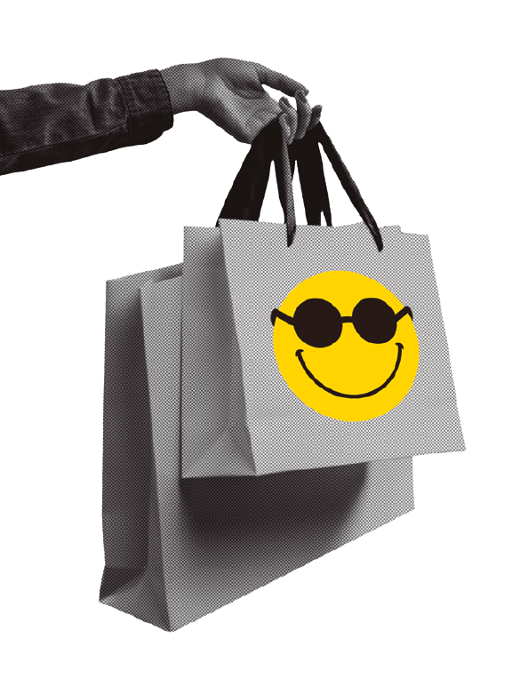 image: Black and white photograph. Focus on a person's hands holding two paper bags with the Dorina Nowill Foundation logo. end of image.