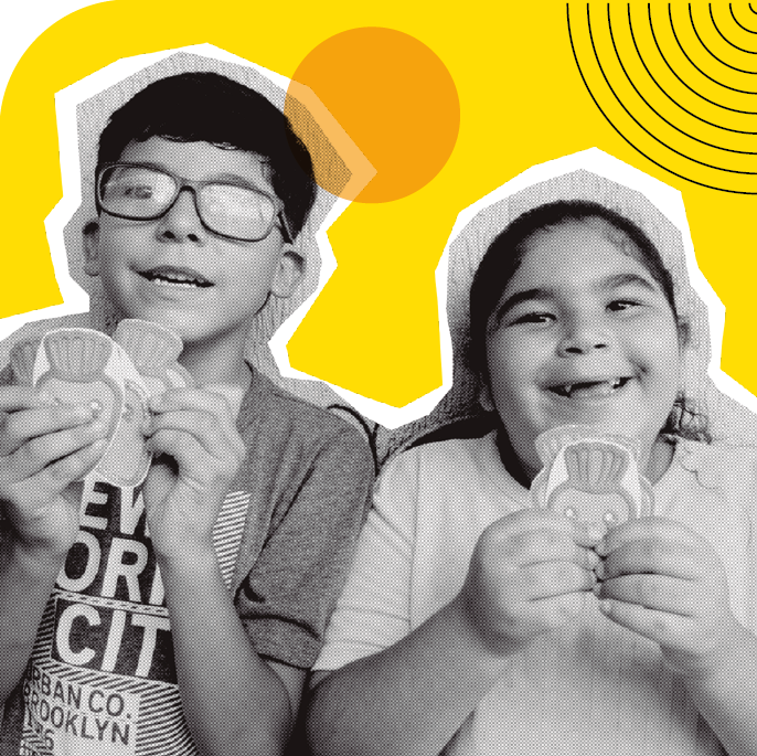 image: Photomontage. Black and white photograph, on the left, a boy with short hair, wearing glasses and a printed shirt. On the right, a girl with her hair tied back in a ponytail, wearing a light-colored shirt. Both are holding cards illustrated with drawings of carrots with eyes and mouths, and they are smiling. In the background, there is an illustration of a yellow circle and black curved lines forming a semicircle. end of image.